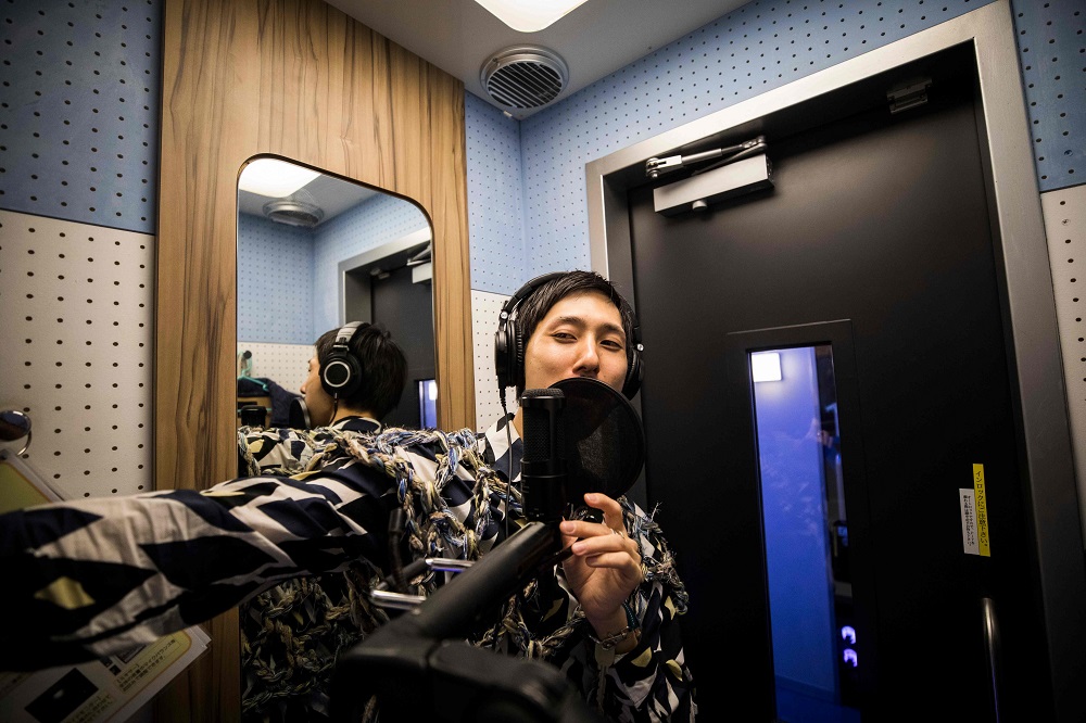 In this photo taken on September 26, 2018, 33-year-old Japanese man Masaki Kitakoga sings alone in a tiny booth at a karaoke parlour in Tokyo. — AFP pic