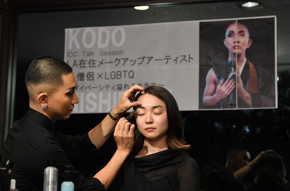 In this photo taken on July 5, 2018, Japanese make-up artist and Buddhist monk Kodo Nishimura (left) shows his technique to a model, Yuri Hotta during the talk session at the Waseda University in Tokyo. u00e2u20acu201d AFP pic 