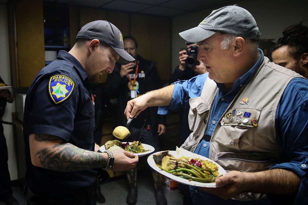 Chef Jose Andres gives Paradise Police Department officer Tanner Ramlow a plate of Thanksgiving dinner at the Paradise Police Department in Paradise, California, November 22, 2018. u00e2u20acu201d Reuters pic