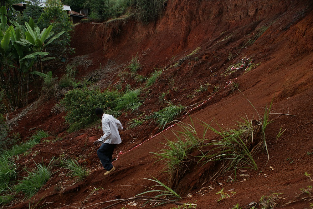 Zachary Muriu at the site of a 2016 landslide that swept away homes and killed one person at Makomboki village in central Kenya October 25, 2018. u00e2u20acu201d Thomson Reuters Foundation pic