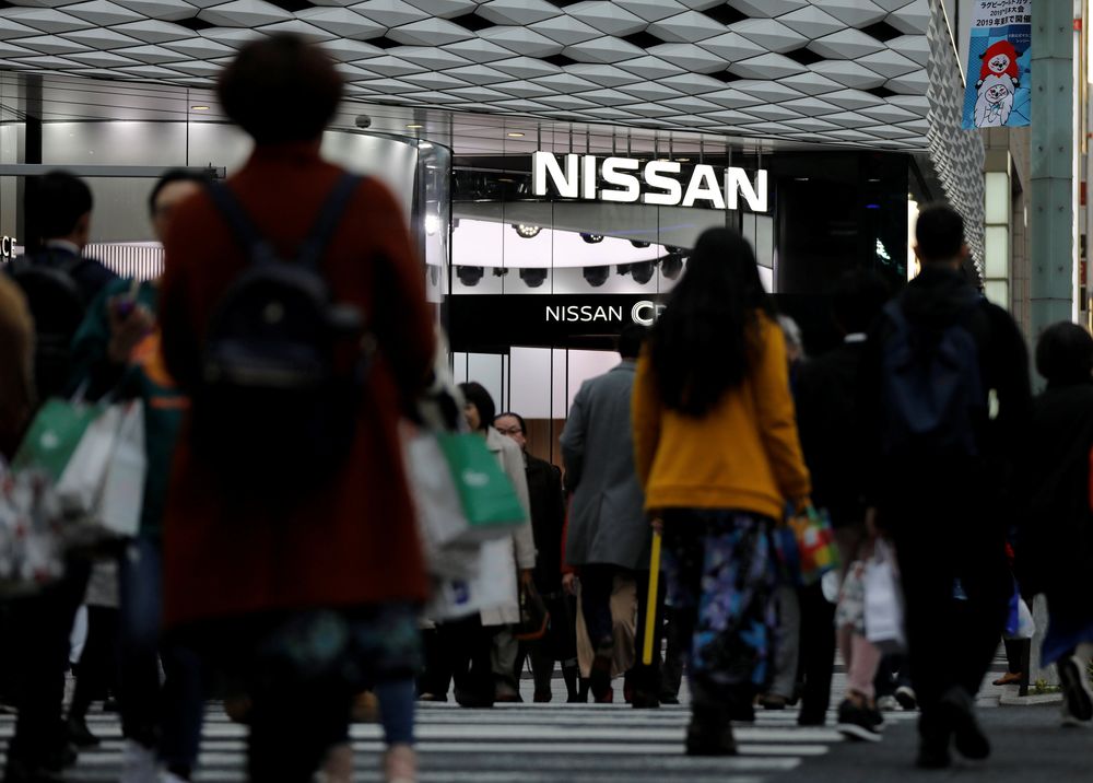 People walk past a Nissan Motor Cou00e2u20acu2122s showroom in Tokyo, Japan November 20, 2018. u00e2u20acu201d Reuters pic