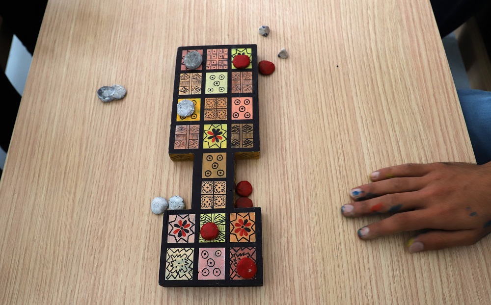 Iraqi artist Hoshmand Mofaq sits over an ancient board game, known as the Royal Game of Ur, in the northern Iraqi city of Raniey October 22, 2018. u00e2u20acu201d AFP pic