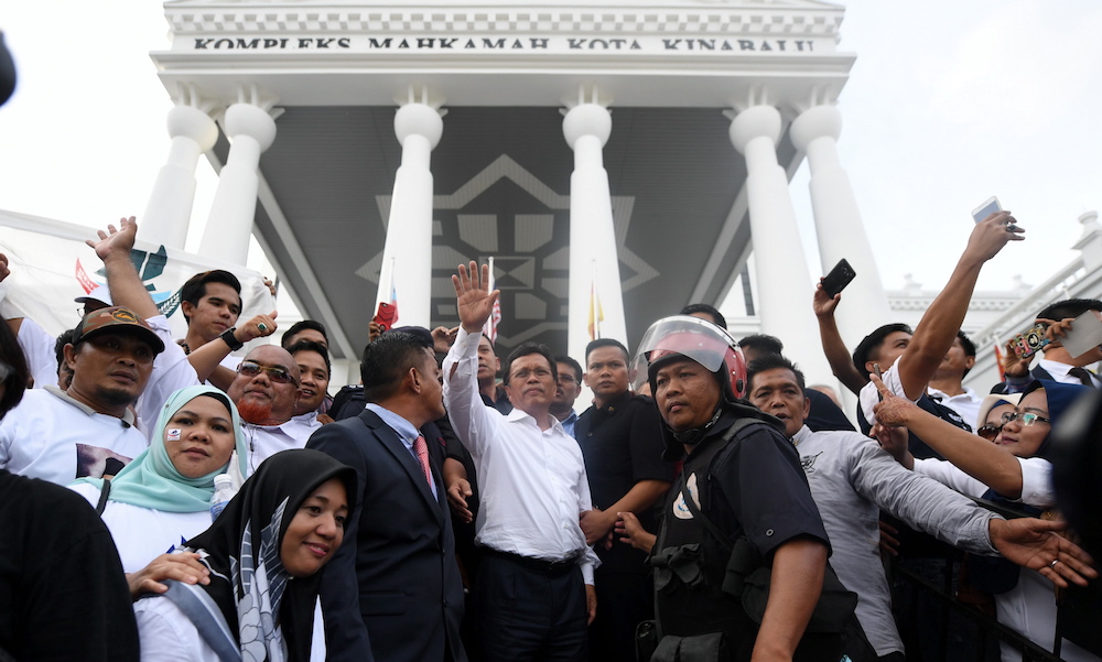 Sabah Chief Minister Datuk Seri Shafie Apdal greets supporters outside the Sabah High Court in Kota Kinabalu November 7, 2018. u00e2u20acu201d Bernama pic