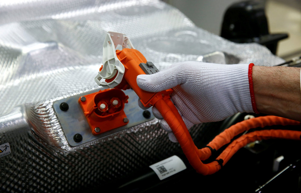 A worker connects the battery during the assembly of an e-Golf electric car at the new production line of the Volkswagen factory in Dresden, Germany March 30, 2017. u00e2u20acu201d Reuters pic