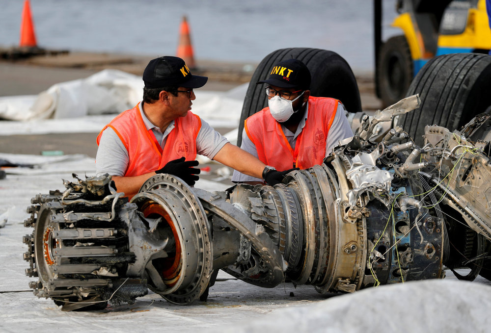 Indonesian National Transportation Safety Commission (KNKT) officials examine a turbine engine from the Lion Air flight JT610 at Tanjung Priok port in Jakarta November 4, 2018. u00e2u20acu201d Reuters pic