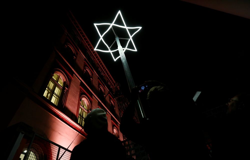 People take pictures of a light symbol, marking the place where Viennese synagogues once stood before they were destroyed in Vienna, Austria November 8, 2018. u00e2u20acu201d Reuters pic