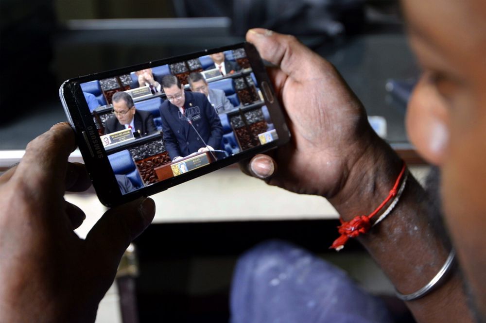 A man watches the tabling of Budget 2019 on his phone in Sentul November 2, 2018. u00e2u20acu2022 Picture by Ham Abu Bakar
