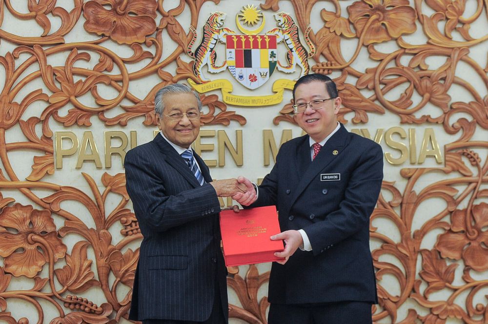 Finance Minister Lim Guan Eng and Prime Minister Tun Dr Mahathir Mohamad pose with a copy of the Budget 2019 report in Parliament November 2, 2018. u00e2u20acu201d Picture by Shafwan Zaidon