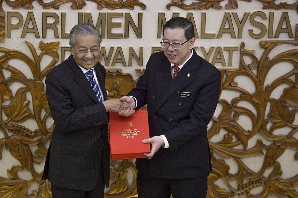 Finance Minister Lim Guan Eng and Prime Minister Tun Dr Mahathir Mohamad pose with a copy of the Budget 2019 report in Parliament November 2, 2018. u00e2u20acu201d Picture by Mukhriz Hazim