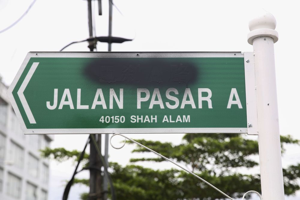 The Chinese characters on a road sign in Shah Alam were sprayed over with black paint.