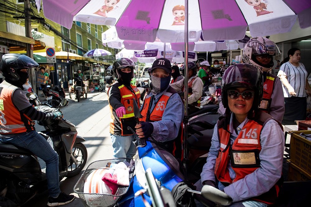Three female motorcycle-taxi drivers waiting at a motorcycle-taxi stand in Bangkok. u00e2u20acu201d AFP pic