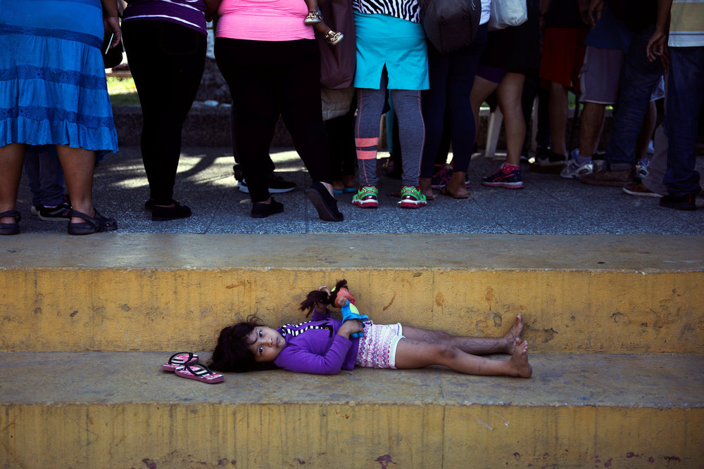 A girl plays with her doll next to migrants, part of a caravan travelling to the US waiting to cross the border between Guatemala and Mexico, in Tecun Uman, Guatemala November 20, 2018. u00e2u20acu201d Reuters pic