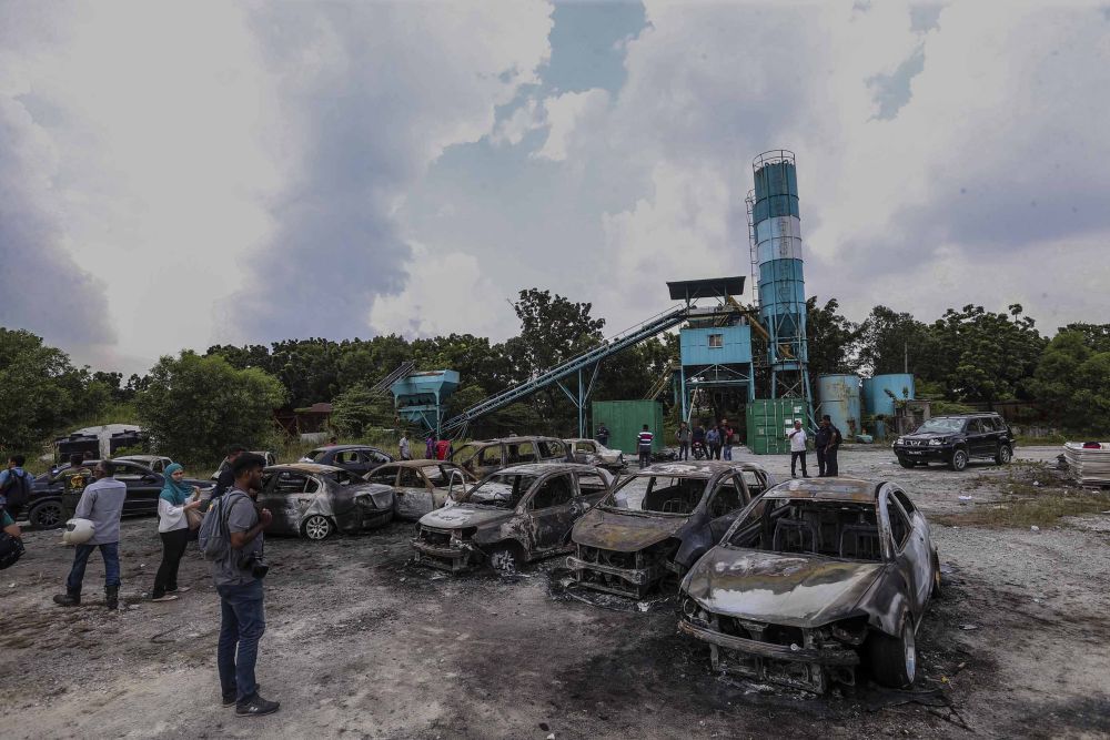 The scene outside the Sri Maha Mariamman Temple in Putra Heights. Eighteen cars and two motorcycles were torched during the incident that started at about 2am. u00e2u20acu2022 Picture by Firdaus Latif