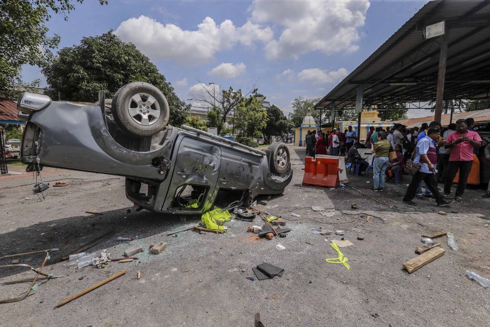 The riots at a temple in Subang Jaya last week caused a fireman to be hospitalised, while vehicles were destroyed and property damaged. ― Picture by Firdaus Latif
