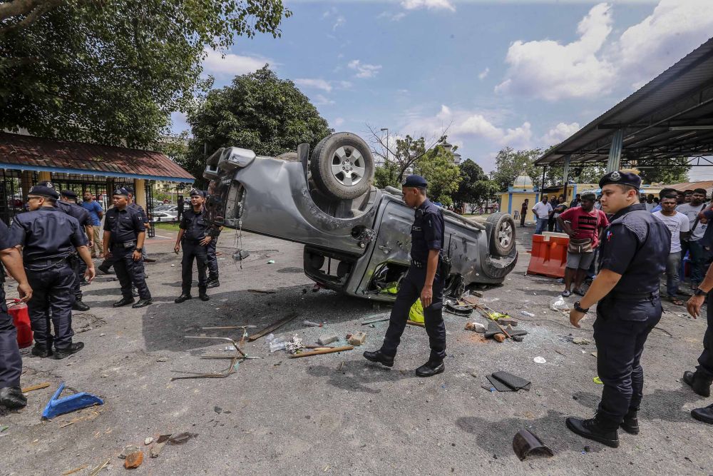 The scene outside the Sri Maha Mariamman Temple in Putra Heights. Eighteen cars and two motorcycles were torched during the incident that started at about 2am. u00e2u20acu2022 Picture by Firdaus Latif