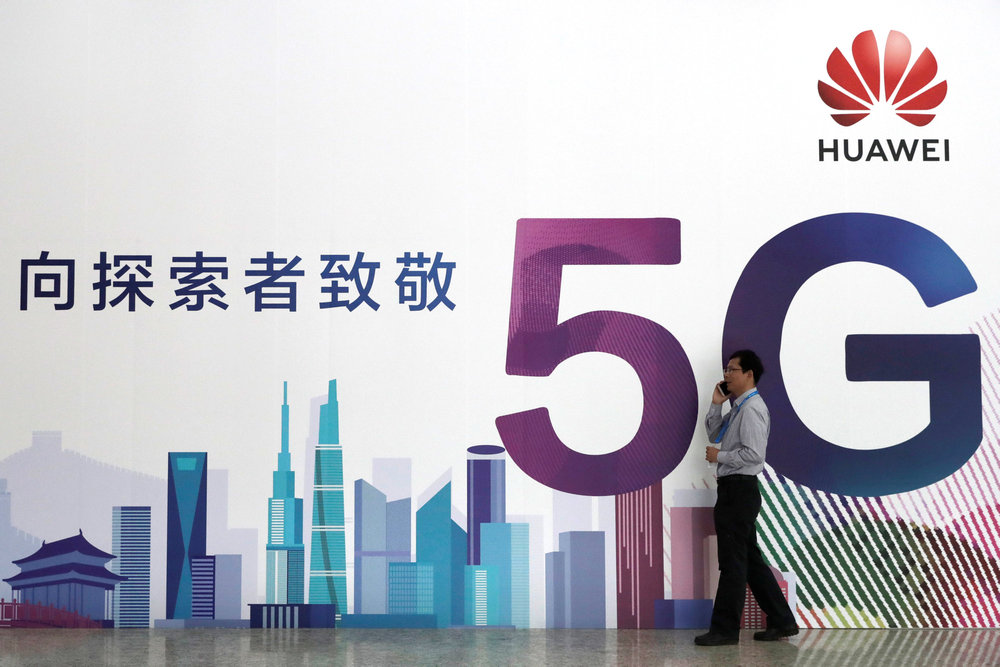 A man talks on his phone beside a Huawei's billboard featuring 5G technology at the PT Expo in Beijing, China September 26, 2018. u00e2u20acu201d Reuters pic