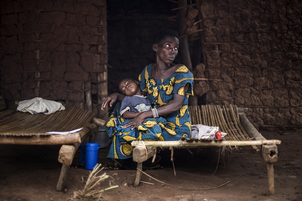 A mother and her sick child wait at a makeshift paediatric health centre as an outbreak of malaria hit their village in Muma, Congo. u00e2u20acu201d AFP pic