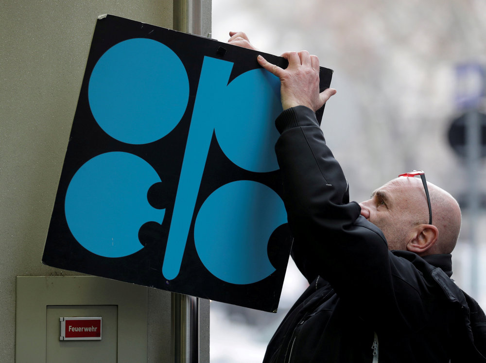 A man fixes a sign with Opec's logo next to its headquarters' entrance before a meeting of Opec oil ministers in Vienna November 29, 2017. u00e2u20acu201d Reuters pic