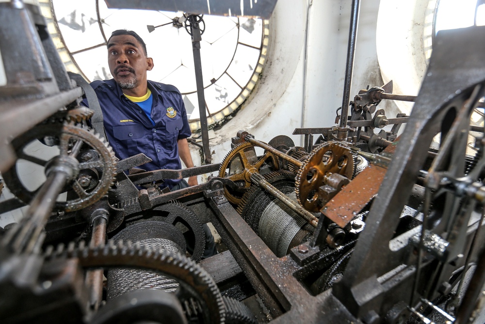 Ahmad Fuzil Hussainsa seen checking the mechanism as he restarts the clock at the Queen Victoria Memorial Clock Tower. 