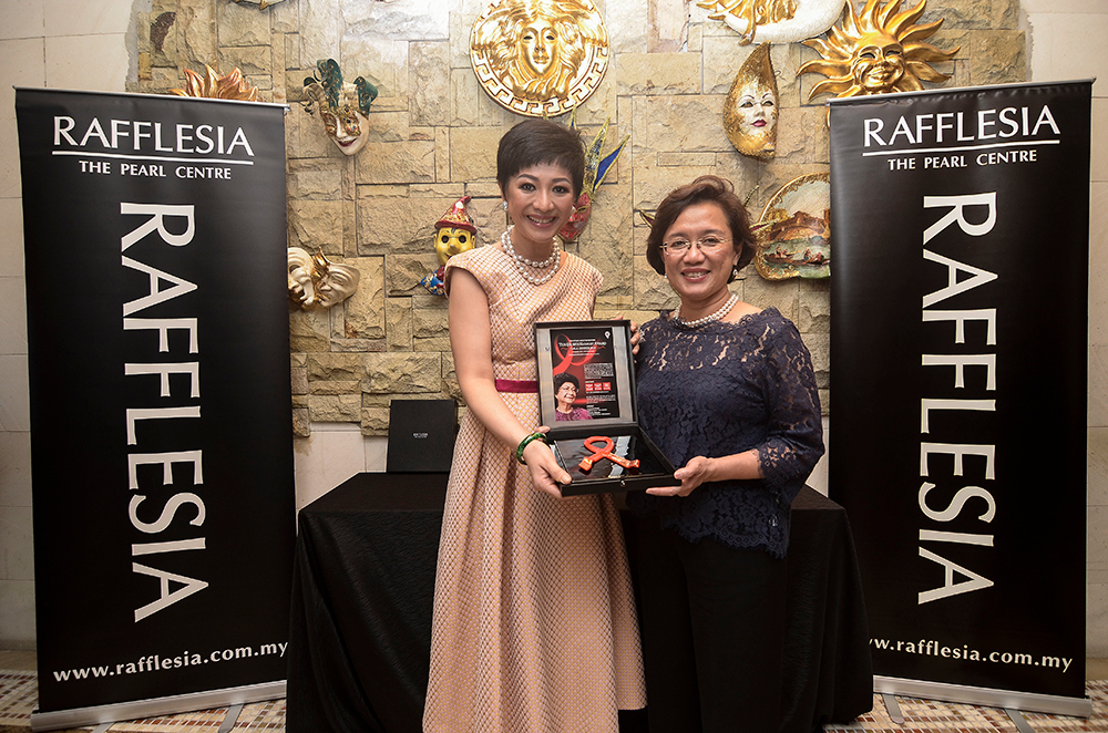 Rafflesia director Winnie Sin (left) and MAF chairperson Prof Datuk Dr Adeeba Kamarulzaman posing with one of the patron's awards at Le Mu00c3u00a9ridien Hotel November 12, 2018. u00e2u20acu201d Pictures by Miera Zulyana