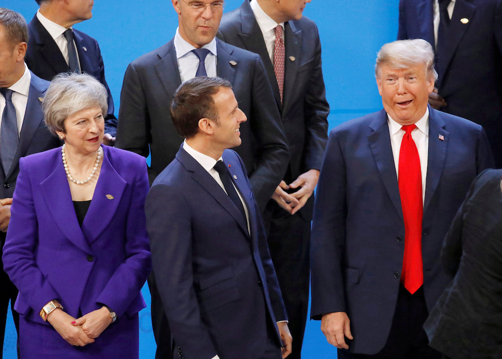 Britain's Prime Minister Theresa May, French President Emmanuel Macron and US President Donald Trump are seen before the family photo during the G20 summit in Buenos Aires November 30, 2018. u00e2u20acu201d Reuters pic