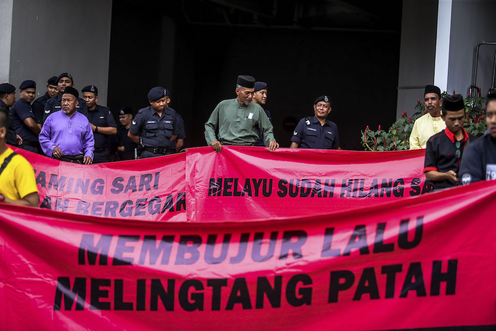 Participants hold banners during the ‘Himpunan Jihad Perkasa’ rally in Kampung Baru, Kuala Lumpur December 2, 2018. — Picture by Hari Anggara