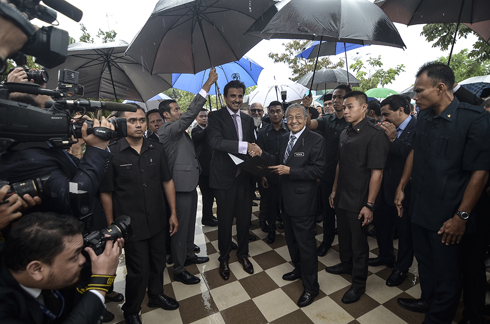 Tun Dr Mahathir Mohamad shakes hands with the Emir of Qatar Sheikh Tamim Hamad Al Thani in Putrajaya December 7, 2018. u00e2u20acu201d Picture by Miera Zulyana