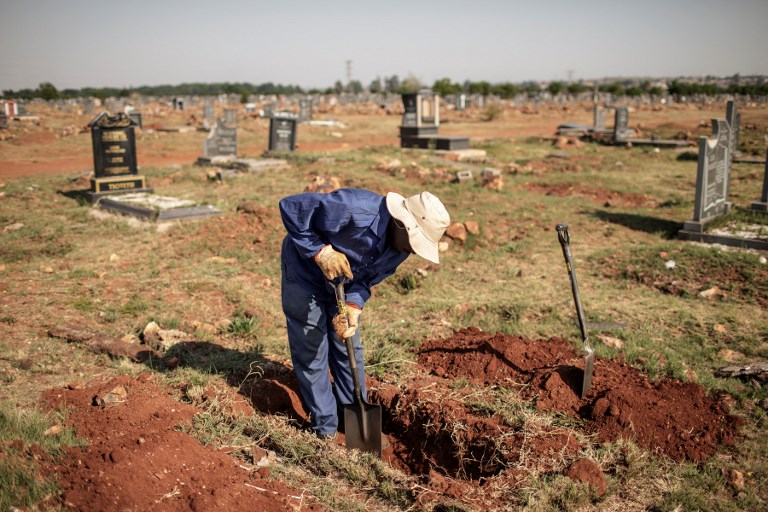 An Avalon Cemetery worker digs a grave in on the graveyard section at the Avalon Cemetery in Soweto on November 15, 2018 in Johannesburg, South Africa. u00e2u20acu201d AFP pic