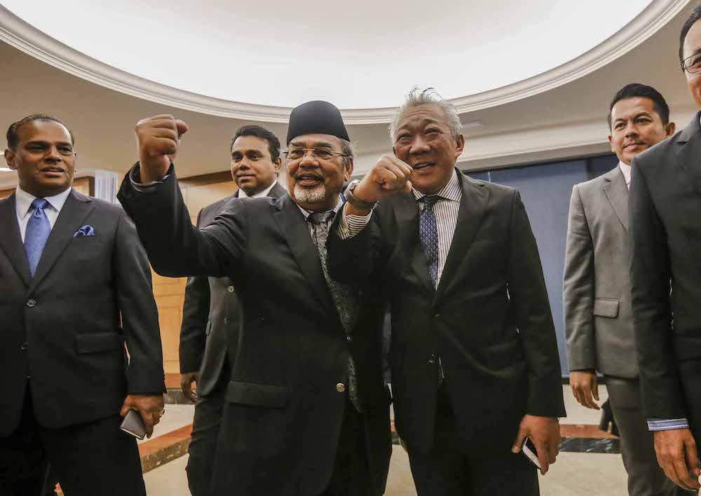 Datuk Seri Tajuddin Abdul Rahman and Datuk Bung Moktar Radin walk out of Dewan Rakyat in a show of protest in Parliament December 10, 2018. — Picture by Firdaus Latif