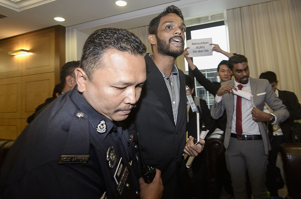 Student activist Sharan Raj is almost escorted out of Parliament December 11, 2018. — Picture by Miera Zulyana