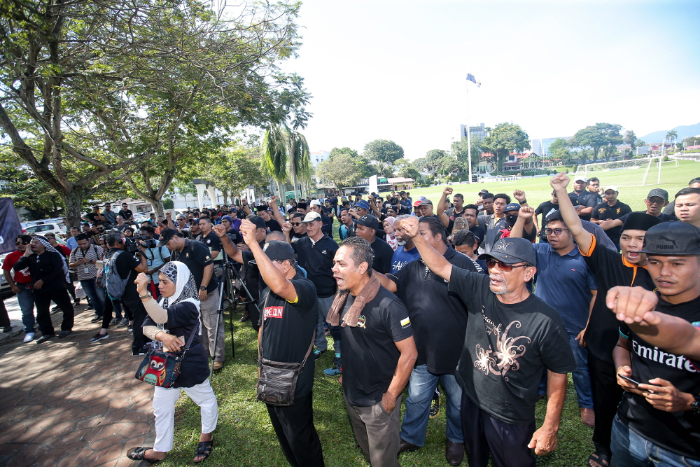A group of people, mostly dressed in black, gathered at the Ipoh Padang, Ipoh to demand justice for Adib and repeatedly shouted for Tun Dr Mahathir Mohamad to resign as the prime minister, December 22, 2018.
