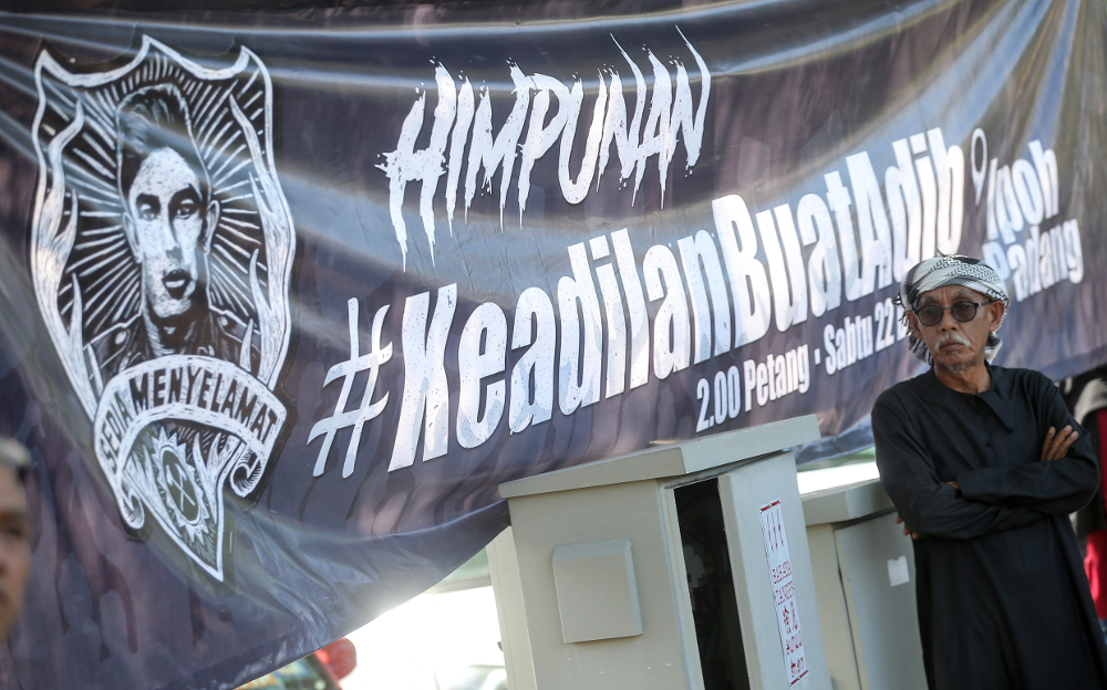 A banner is seen at a gathering of Malay groups in Ipoh to demand justice for Muhammad Adib Mohd Kassim December 22, 2018.