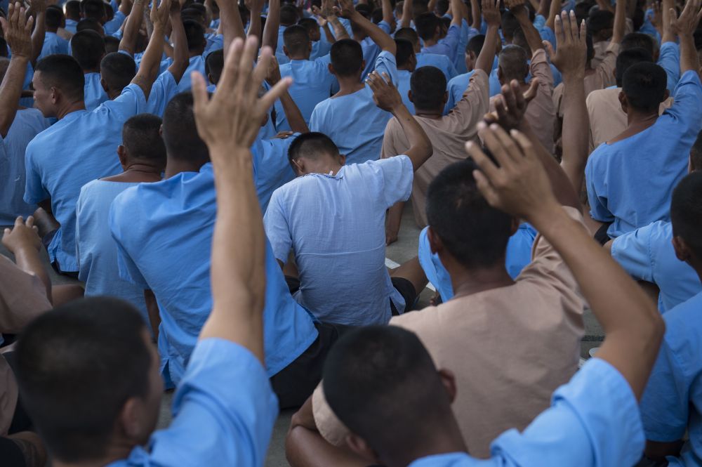 This photo taken February 8, 2018 shows inmates sitting inside the courtyard of a prison in the central Thai province of Nakhon Nayok. u00e2u20acu201d AFP pic