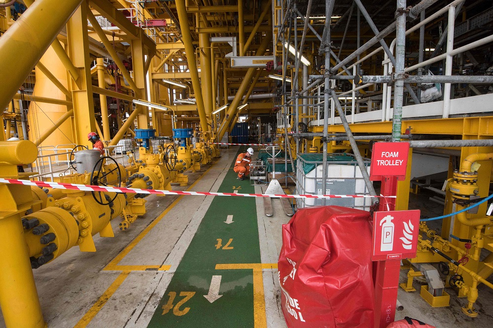 A worker works on the Kaombo Norte, an oil tanker converted into a FPSO vessel (Floating Production Storage and Offloading), owned by the French Total oil company, on November 8, 2018, about 250km off the coast of Angola in the Atlantic Ocean. — AFP pic