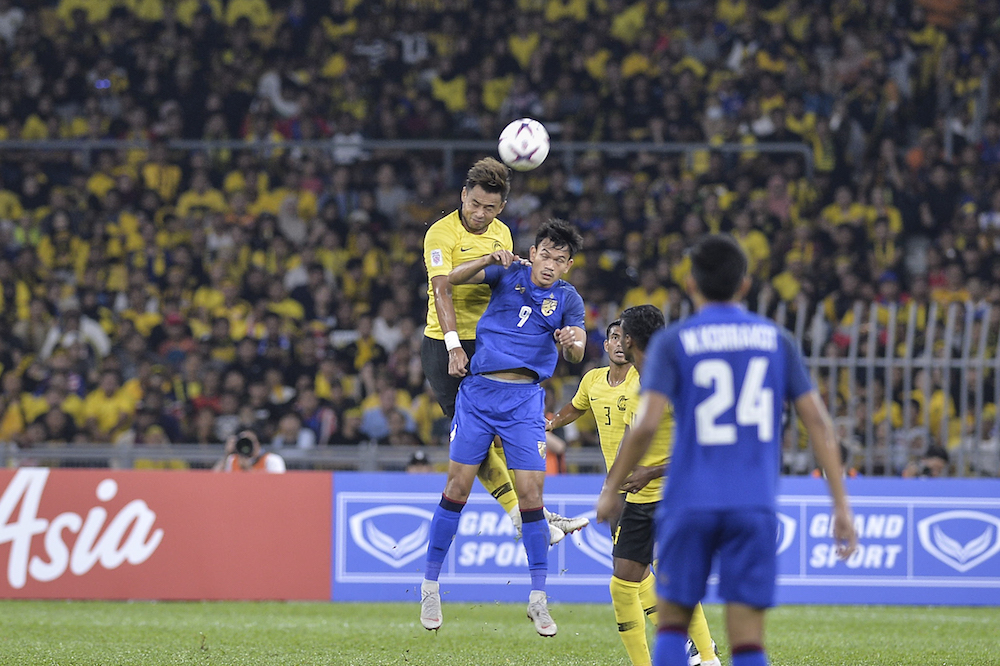 Malaysia player, Aidil Zafuan Radzak jump for the ball during the AFF Suzuki Cup semi final match between Malaysia and Thailand 2018 in National Stadium Bukit Jalil in Kuala Lumpur December 1, 2018. u00e2u20acu201d Picture by Shawan Zaidonn