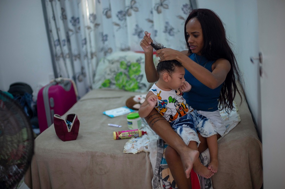Brazilian Thamires Cristina dos Santos Ferreira da Silva, 29, combs the hair of her two-year-old son Matheus Silva, who was born with microcephaly, at their apartment in Belford Roxo, Rio de Janeiro, Brazil November 30, 2018.  u00e2u20acu201d AFP pic 
