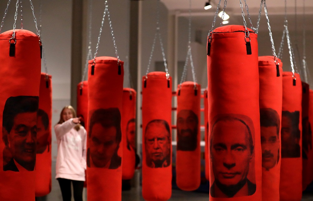 A visitor looks at punching bags with images depicting political figures, as part of an installation called u00e2u20acu02dcWelcome in Hard Timesu00e2u20acu2122, that allows visitors to release their frustrations on the bags, in Prague December 10, 2018. u00e2u20acu201d Reuters pic