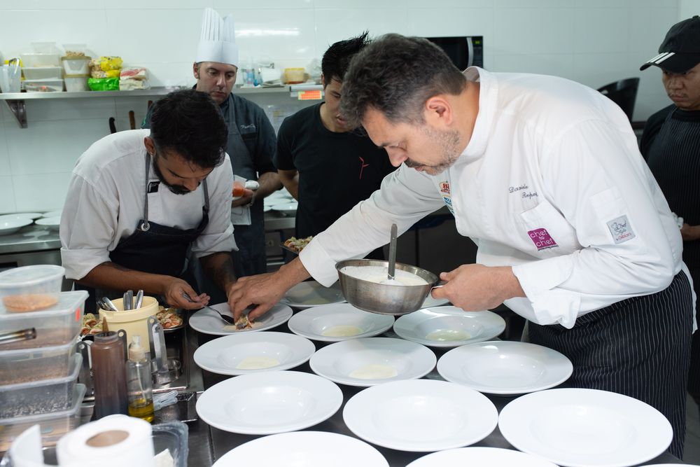 Michelin-star chef Daniele Repetti (right) puts the finishing touches to one of the courses.