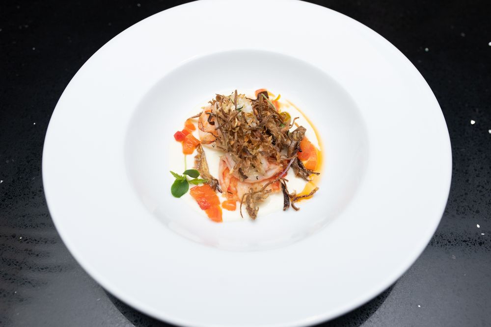 Tiger prawns coated with herb breadcrumbs, Burrata cream, fried artichokes and tomato confit.