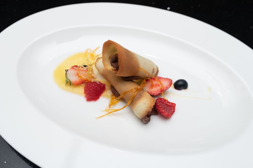 Biscuit cones filled with dark chocolates, tangy citrus sauce and forest fruits.