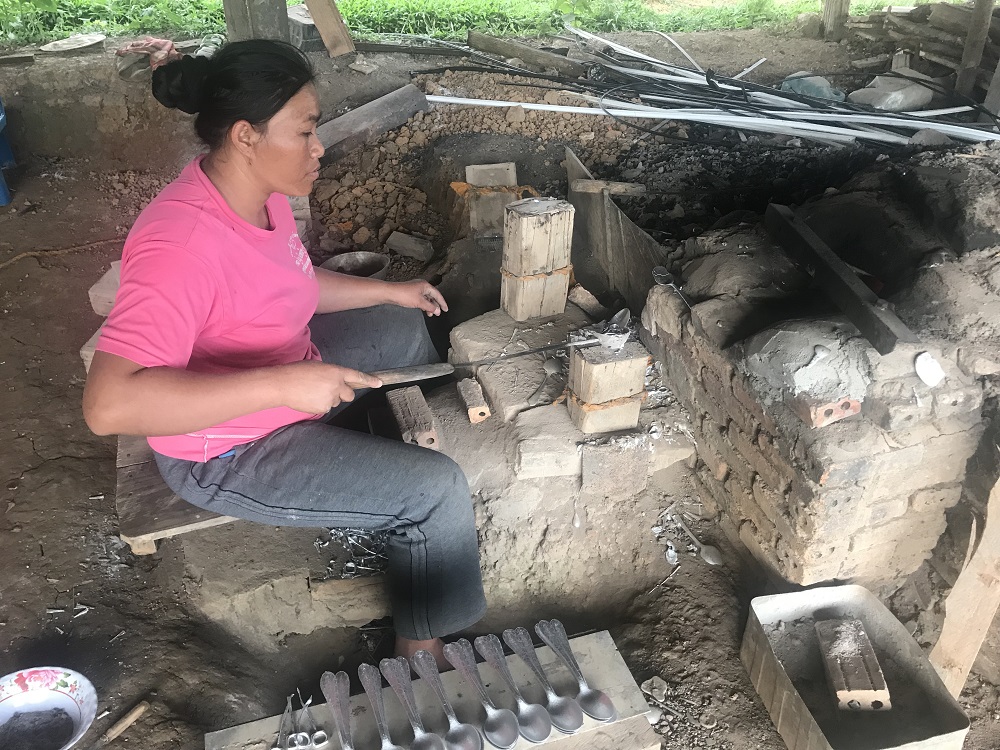 A villager fashions items from bomb shrapnel at her kiln in Ban Napia, Laos October 16, 2018. — Thomson Reuters Foundation pic