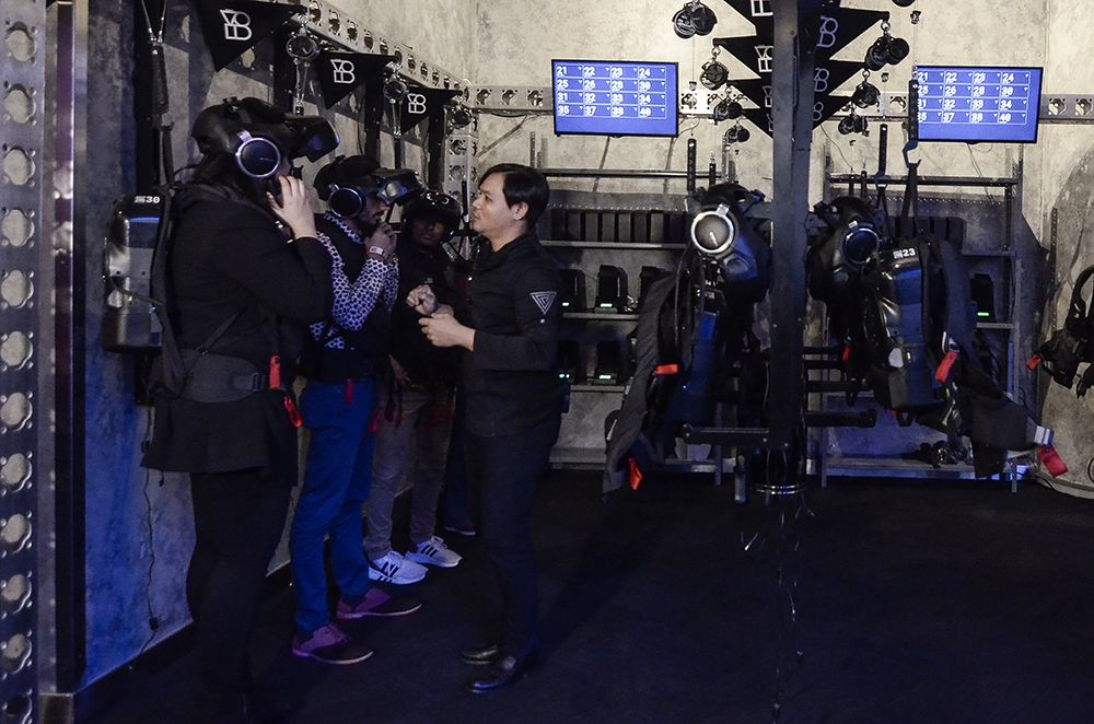 Visitors gear up before heading to the room for their experience.