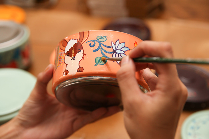 The designs are transferred and hand painted on the stainless steel tiffins