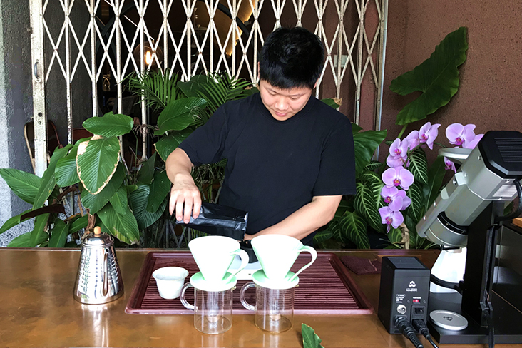Joey Mah brewing coffee using direct-sourced beans