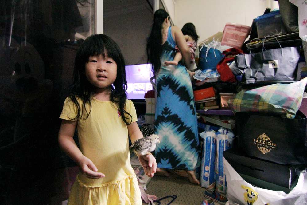 Jubilee, 3, holds one of three chicks that her mother Singaporean freegan Sarah Ng (centre) says she rescued, as she poses for a photo at their house in Singapore November 11, 2018. — Reuters pic