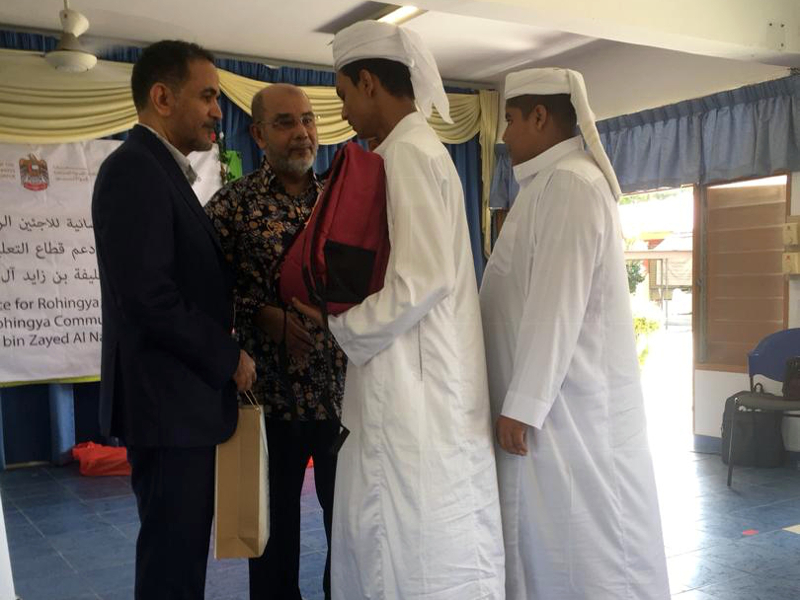 UAE ambassador to Malaysia Khalid Granim Mohamad Al-Ghaith (left) and Tan Sri Syed Hamid Albar (2nd left) hand out school bags and uniforms to Mohd Yasin Abdul Hakim (2nd right) and Mohd Altaf Azmel Husin (right). u00e2u20acu201d Picture by Wong Sai Wan