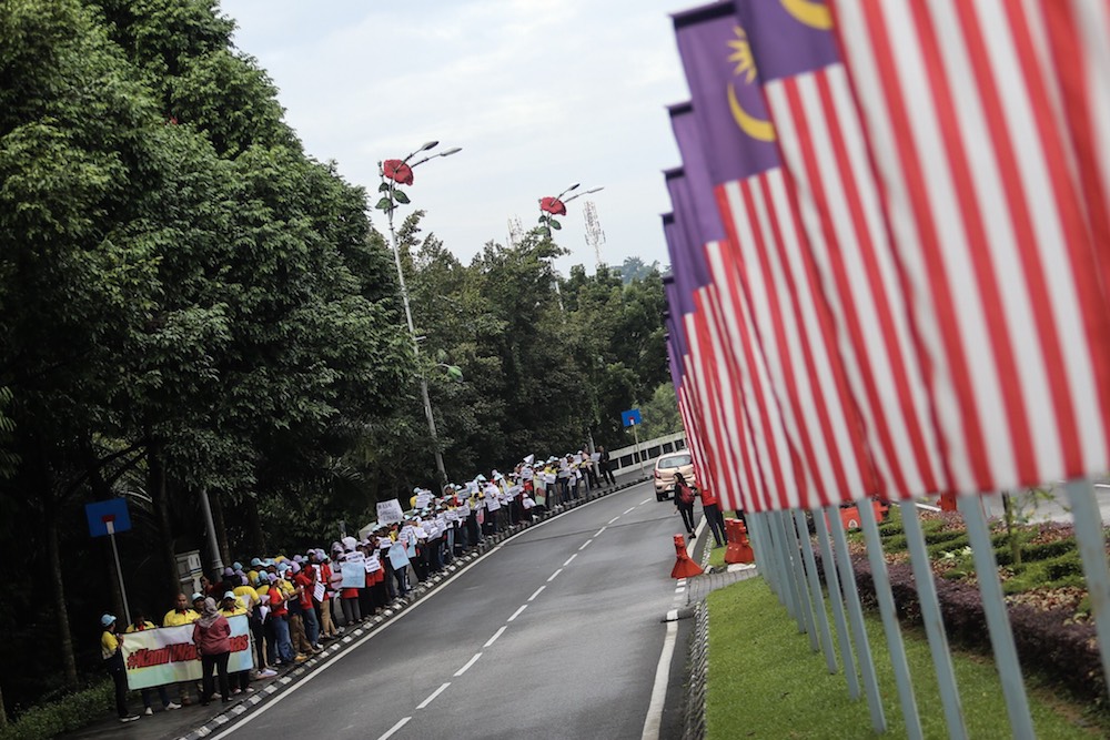 Lynas employees demonstrate in front of the Parliament compound in Kuala Lumpur December 11, 2018. — Picture by Hari Anggara