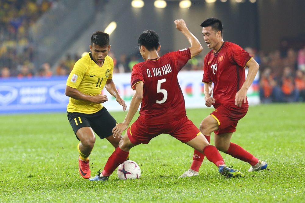 Malaysia's Muhammad Safawi Rasid (left) in action against Vietnam during the first leg of the AFF Suzuki Cup final at the Bukit Jalil Stadium December 11, 2018. — Picture by Ahmad Zamzahuri