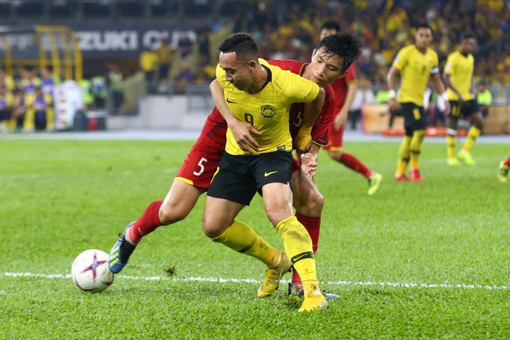 Malaysia's Norsharul Idlan Talaha (9) in action against Vietnam during the first leg of the AFF Suzuki Cup final at the Bukit Jalil Stadium December 11, 2018. u00e2u20acu201d Picture by Ahmad Zamzahuri