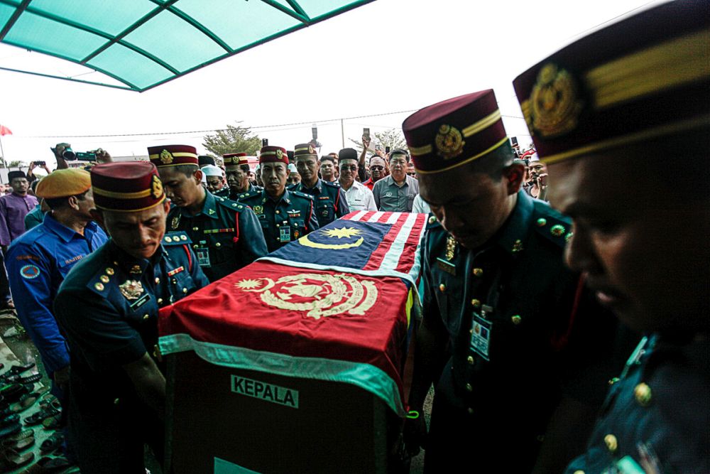 Fire and Rescue Department personnel carry Muhammad Adibu00e2u20acu2122s coffin into the As-Saadah Mosque in Alor Setar December 18, 2018. u00e2u20acu201d Picture by Sayuti Zainudin